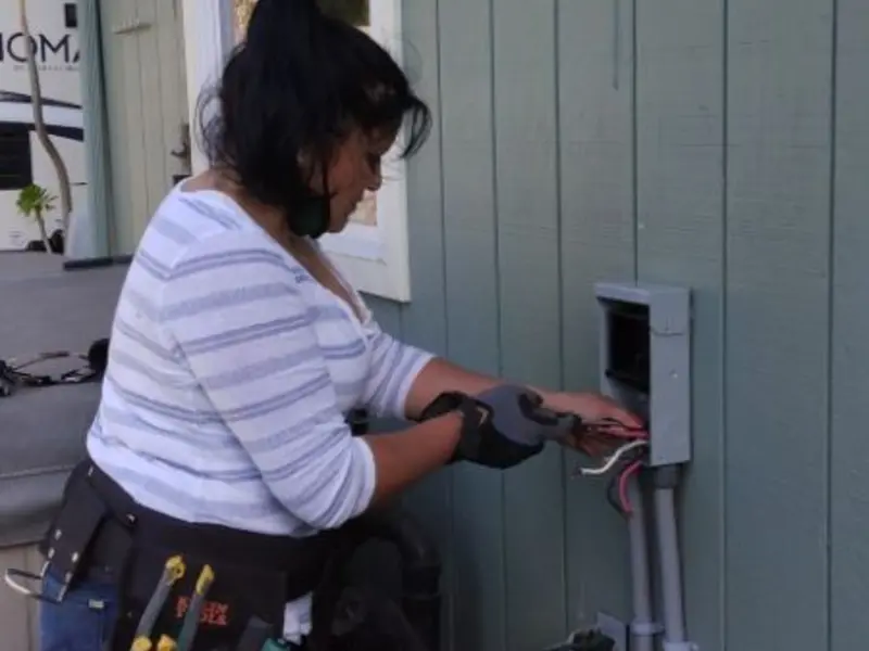 Licensed electrician wiring an exterior subpanel in Cloverleaf